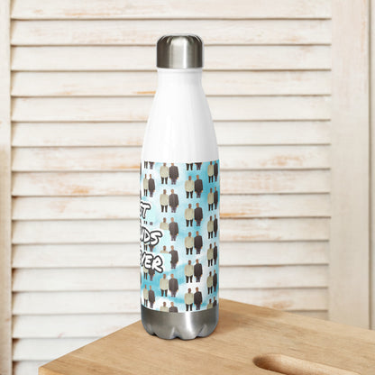 White water bottle with a patterned label on a wooden surface with a light wooden panel background