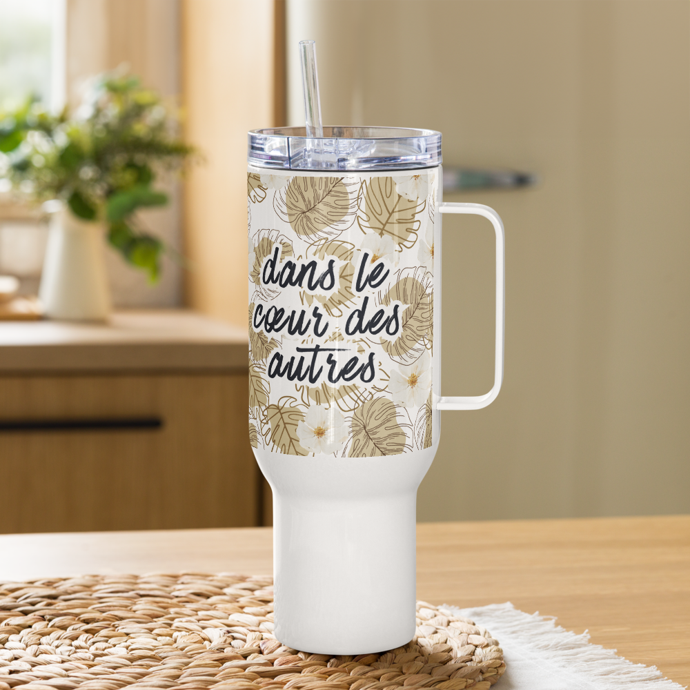 White tumbler with floral design and text on a wooden surface